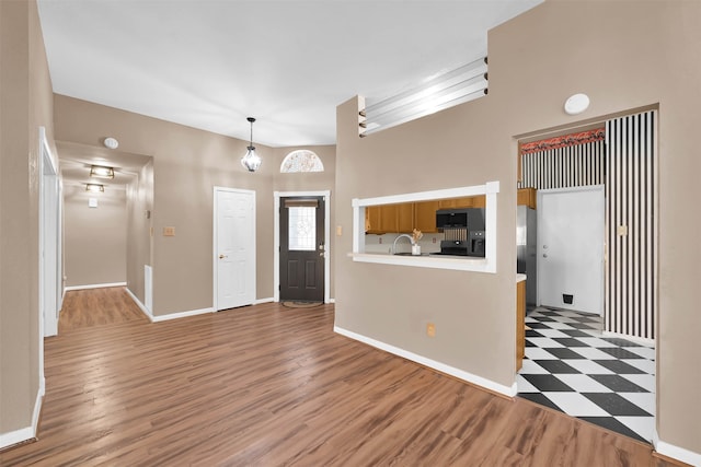 entrance foyer featuring a towering ceiling and dark hardwood / wood-style flooring