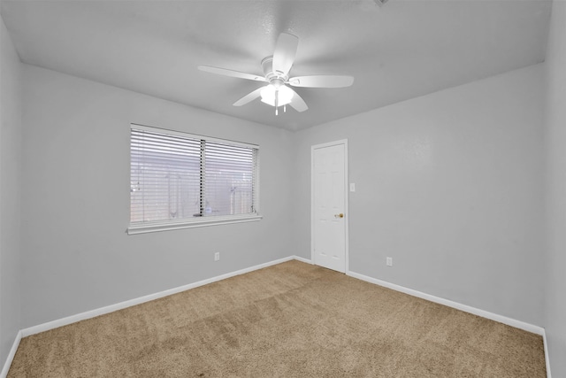 empty room with ceiling fan and carpet