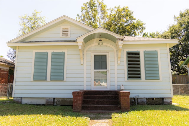 rear view of property with a lawn