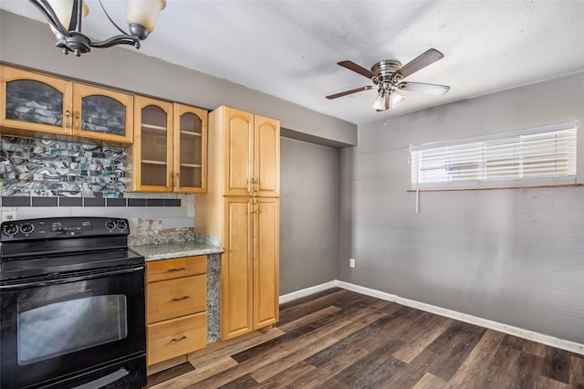 kitchen with light stone counters, light brown cabinets, black electric range, dark hardwood / wood-style floors, and ceiling fan with notable chandelier