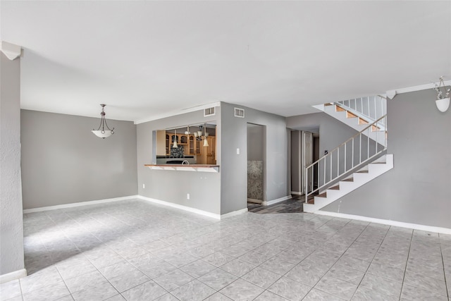 unfurnished living room with a notable chandelier