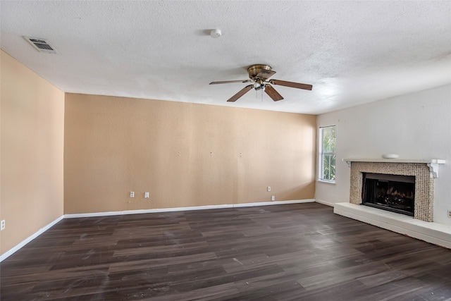 unfurnished living room featuring ceiling fan, a textured ceiling, and dark wood-type flooring