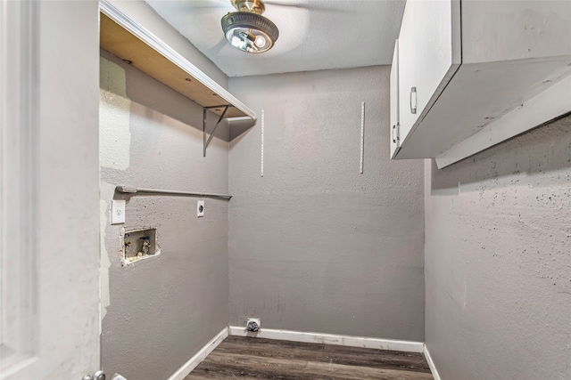 clothes washing area with cabinets, electric dryer hookup, washer hookup, and dark hardwood / wood-style flooring