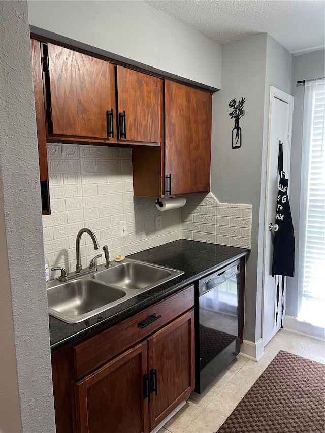 kitchen featuring backsplash, black dishwasher, light tile patterned floors, a textured ceiling, and sink