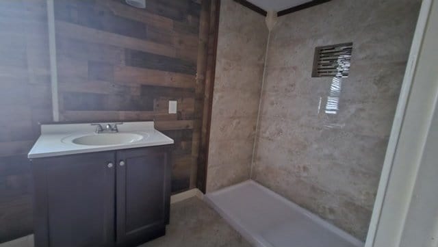 bathroom with walk in shower and vanity