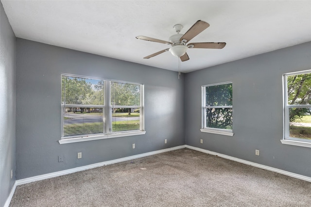 carpeted spare room with ceiling fan