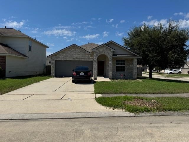 view of front of house with a front lawn and a garage