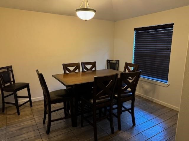 dining area with dark tile patterned flooring