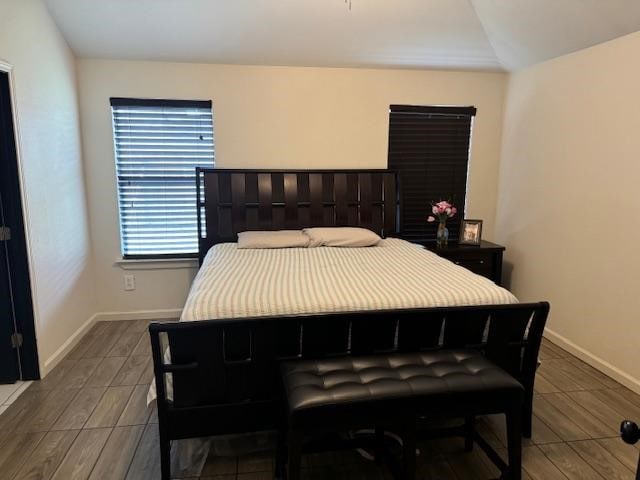 bedroom featuring vaulted ceiling and hardwood / wood-style floors