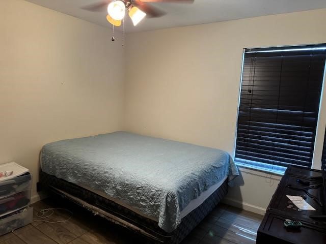 bedroom featuring ceiling fan and dark hardwood / wood-style floors