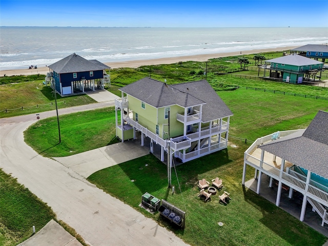 aerial view with a water view and a beach view