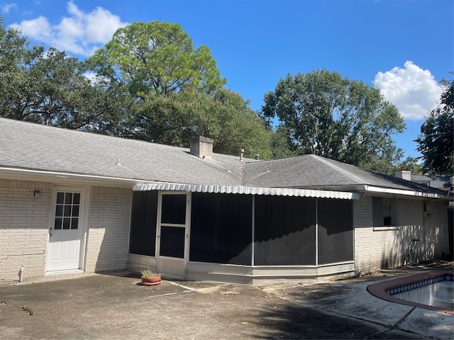 back of house featuring a sunroom