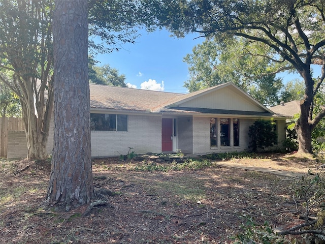 single story home with roof with shingles, fence, and brick siding