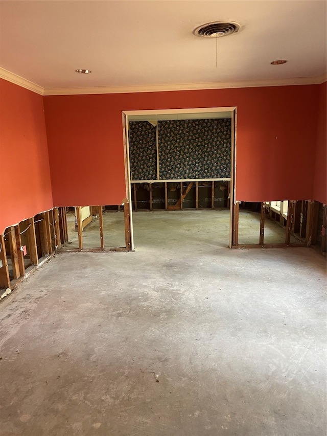 spare room with concrete flooring and crown molding