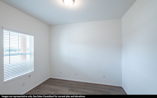 spare room featuring dark hardwood / wood-style flooring