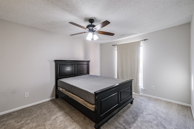 carpeted bedroom with a textured ceiling and ceiling fan