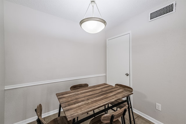 dining room featuring a textured ceiling