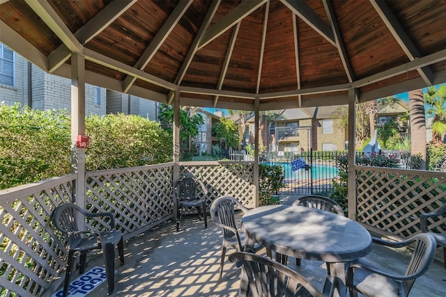 view of patio featuring a community pool and a gazebo