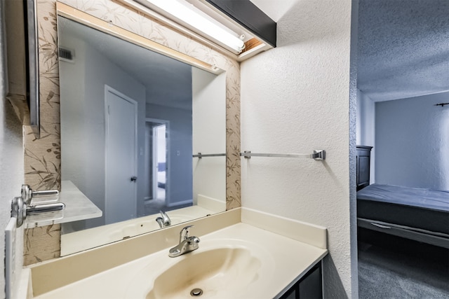 bathroom featuring vanity and a textured ceiling