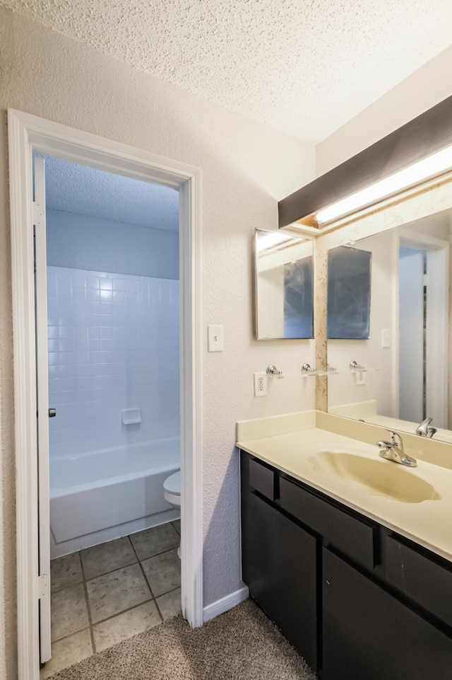 full bathroom featuring a textured ceiling, vanity, toilet, and tile patterned floors