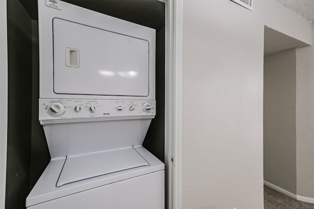 laundry area with stacked washer and clothes dryer