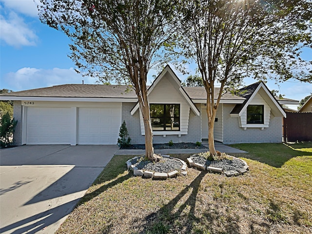 ranch-style home featuring a front yard and a garage