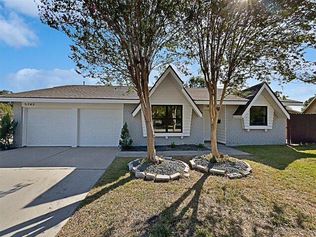 5743 Ludington Dr, Houston, TX 77035 - ranch-style house featuring brick siding, an attached garage, driveway, and a front yard
