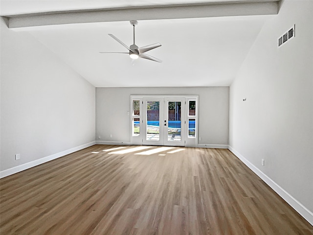 unfurnished living room featuring vaulted ceiling with beams, wood-type flooring, ceiling fan, and french doors