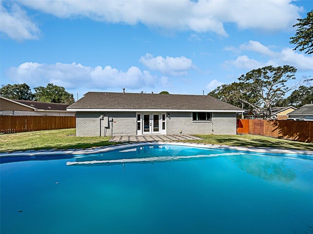 5743 Ludington Dr, Houston, TX 77035 - view of pool with a lawn, a fenced backyard, a fenced in pool, and french doors