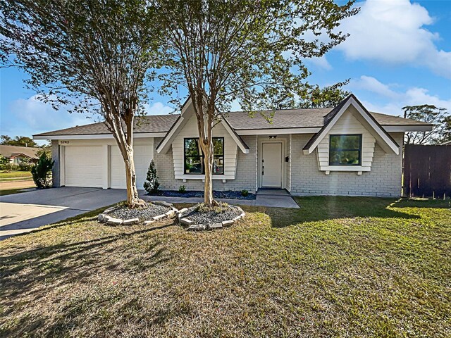 5743 Ludington Dr, Houston, TX 77035 - view of front facade with brick siding, an attached garage, driveway, and a front yard