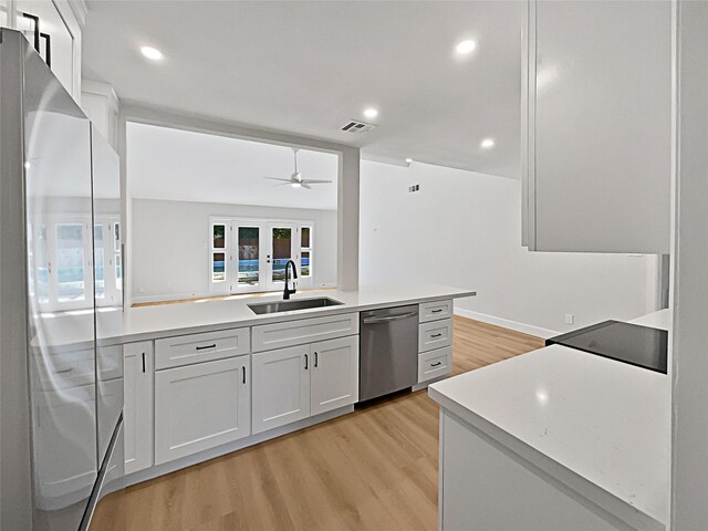 5743 Ludington Dr, Houston, TX 77035 - kitchen with a sink, visible vents, light wood-style floors, white refrigerator, and dishwasher
