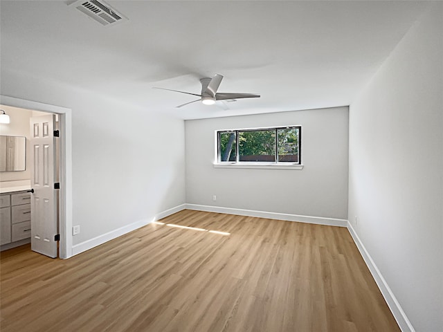 unfurnished bedroom with light hardwood / wood-style floors, ceiling fan, and ensuite bathroom