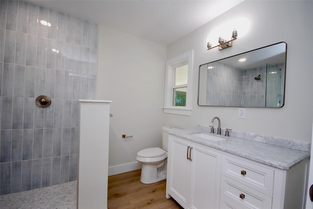 316 N Penn, Flatonia, TX 78941 - bathroom with wood finished floors, vanity, baseboards, toilet, and a walk in shower