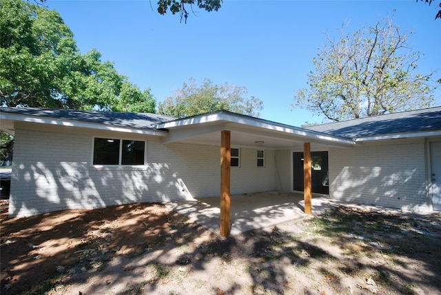 view of side of property with a patio area