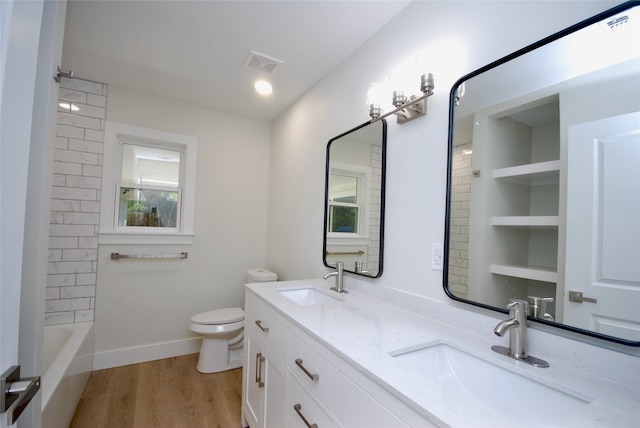 full bathroom with wood-type flooring, vanity, toilet, and tub / shower combination