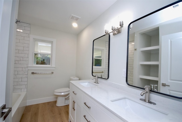 316 N Penn, Flatonia, TX 78941 - full bathroom featuring wood finished floors, visible vents, toilet, and a sink