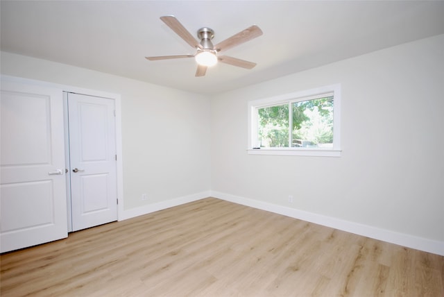 unfurnished bedroom featuring ceiling fan, light hardwood / wood-style flooring, and a closet