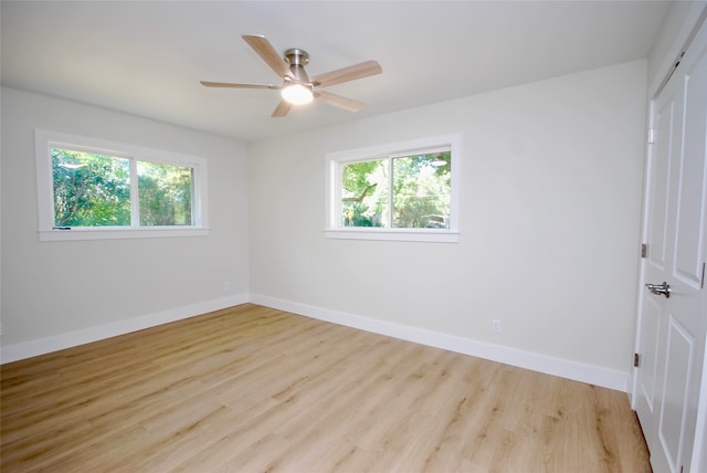 empty room featuring ceiling fan and light hardwood / wood-style floors