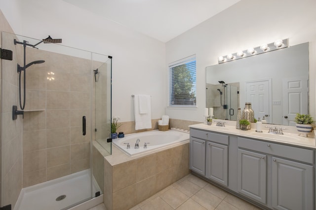 bathroom with tile patterned floors, independent shower and bath, and vanity