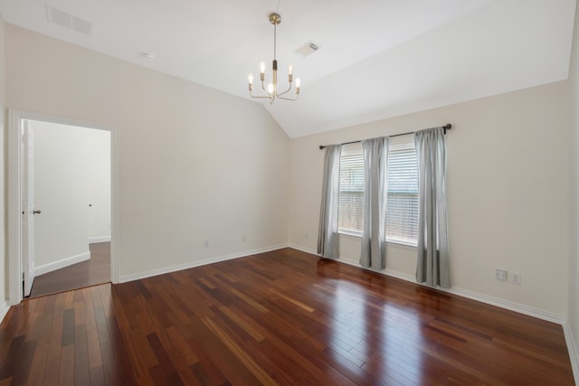 unfurnished room with an inviting chandelier, dark hardwood / wood-style floors, and vaulted ceiling