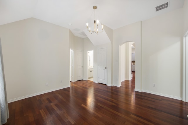 empty room featuring lofted ceiling, a chandelier, and dark hardwood / wood-style flooring