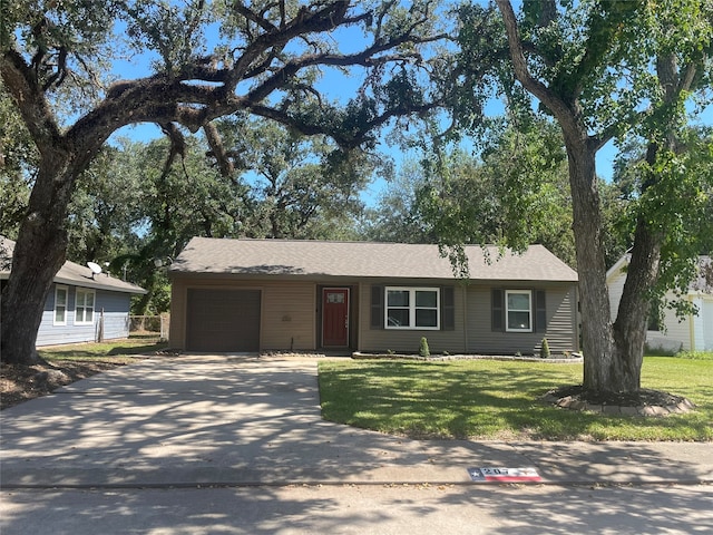 ranch-style house featuring a front yard and a garage