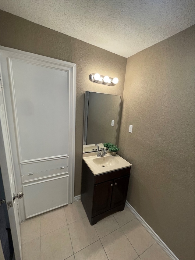 bathroom featuring vanity, a textured ceiling, and tile patterned floors