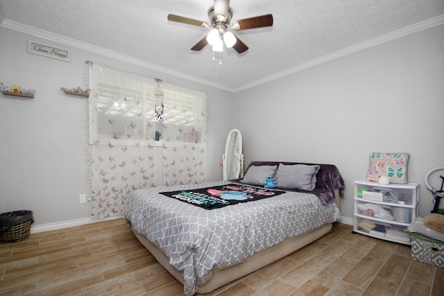 bedroom with a textured ceiling, light hardwood / wood-style floors, ceiling fan, and crown molding