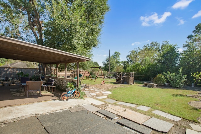 view of yard with a playground and a patio