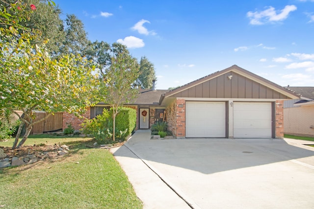 view of front of property with a garage and a front yard