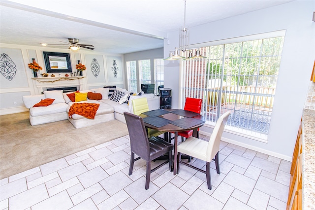 carpeted dining space with ceiling fan with notable chandelier