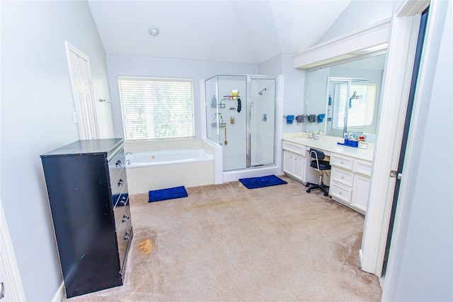 bathroom featuring plus walk in shower, vanity, lofted ceiling, and a healthy amount of sunlight