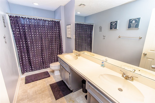 bathroom with vanity, toilet, and curtained shower