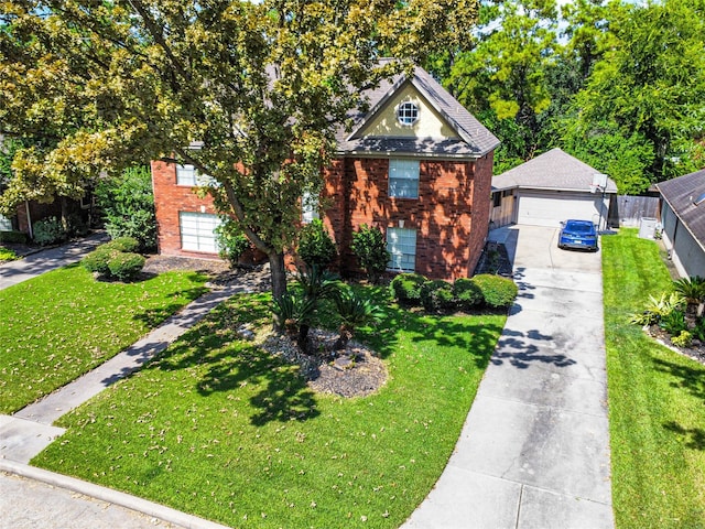 view of front of house featuring a garage, a front lawn, and an outbuilding